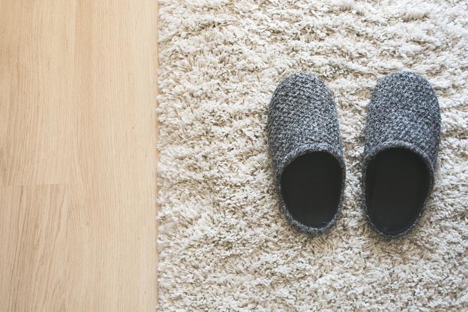 gray slippers on rug